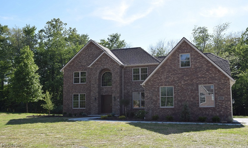 Welcome home to 9662 Amberwood Court in Broadview Heights. This stunning and brand new brick colonial is sure to please even the more selective home buyer. Located on a Cul de Sac street and backing up to a wooded area. The exterior features a three car garage, landscaped beds, concrete patio and brick front. Open the front door to a two story foyer, a formal dining room and a private office. The dramatic large kitchen features an eat in area, large island, granite counter tops, stainless steel appliances, built in wine rack and wine refrigerator. The family room offers a gas fireplace with marble surround and built in bookcases. The first floor bedroom can be used as an in law suite w/ full bath. Crown molding throughout first level. The exquisite master bedroom suite has a lighted tray ceiling and custom crown molding, walk in closet, master bath with jacuzzi tub and ceramic shower surround with built in granite seating and glass doors and a vanity with dual sinks. The finished basem
