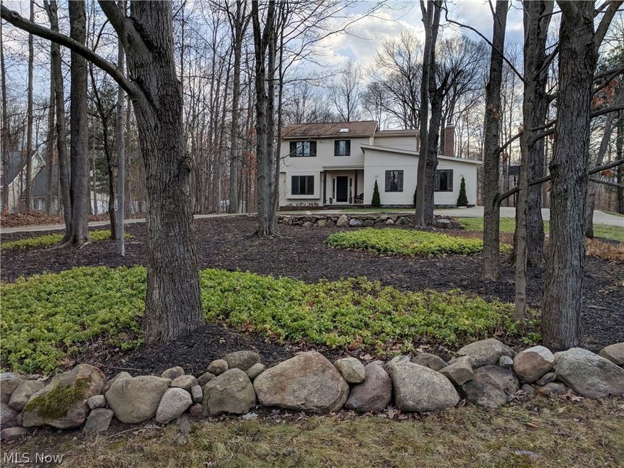 Beautifully Updated 4 Bedroom & 2.5 Bath Colonial nestled on nearly 2 private wooded acres! Foyer entrance welcomes you with new ceramic floors. Formal Living Room has gorgeous hardwood floors through to Dining Room with access to deck. Newly remodeled Kitchen with center island breakfast bar & all stainless steel appliances stay. Family Room with wood burning stove and sliders to 2-tiered deck, brick patio & walkway. Second floor offers 4 Bedrooms including Master with new hardwood floors & private full bath. Finished Basement with Rec/Playroom & laundry area. Enjoy peaceful wooded views out every window. Many other updates include: freshly painted exterior & interior, flooring, lighting fixtures, wood trim, new landscaping & more! 2-car attached garage and circular concrete drive. 24x24 Outbuilding/Polebarn. Close to Bear Town Lakes Reservation & close proximity to Chagrin Falls, Bainbridge & Aurora. 1-yr Home Warranty. Kenston Schools.