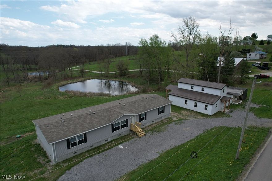 Spacious and inviting, this 5-bedroom, 3 full bath manufactured home sits on nearly 6 scenic acres in a peaceful country setting, complete with a pond and gorgeous views in every direction. This newer home offers an open-concept floor plan, generously sized bedrooms, and oversized closets, providing plenty of space for comfortable living. Recent updates include new front and back steps and a professionally installed foundation, adding both value and peace of mind. The home features electric heat, central air, a 200-amp electrical service, and a newer well and septic system. All appliances convey, making this property truly move-in ready.
Outside, you’ll find a large driveway with ample parking, along with multiple outbuildings for added versatility. A standout feature is the impressive barn-style structure, complete with a back porch showcasing a stunning timber frame cathedral ceiling—an ideal spot to relax and take in peaceful views of the pond. This versatile space is perfect for a workshop, recreation area, or hobby retreat, along with two additional large storage sheds. With endless potential and room to make it your own, this property offers the perfect blend of space, functionality, and rural charm. Schedule your private showing today!