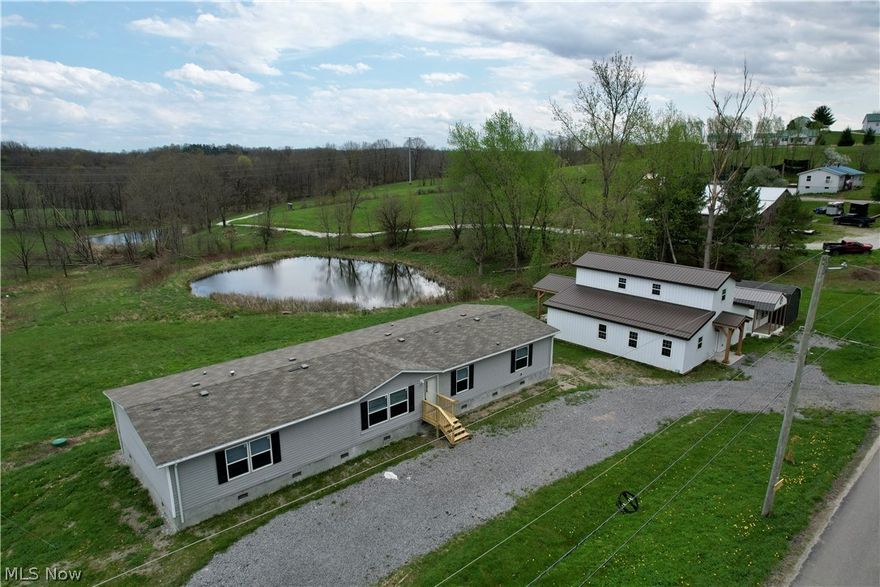 Spacious and inviting, this 5-bedroom, 3 full bath manufactured home sits on nearly 6 scenic acres in a peaceful country setting, complete with a pond and gorgeous views in every direction. This newer home offers an open-concept floor plan, generously sized bedrooms, and oversized closets, providing plenty of space for comfortable living. Recent updates include new front and back steps and a professionally installed foundation, adding both value and peace of mind. The home features electric heat, central air, a 200-amp electrical service, and a newer well and septic system. All appliances convey, making this property truly move-in ready.
Outside, you’ll find a large driveway with ample parking, along with multiple outbuildings for added versatility. A standout feature is the impressive barn-style structure, complete with a back porch showcasing a stunning timber frame cathedral ceiling—an ideal spot to relax and take in peaceful views of the pond. This versatile space is perfect for a workshop, recreation area, or hobby retreat, along with two additional large storage sheds. With endless potential and room to make it your own, this property offers the perfect blend of space, functionality, and rural charm. Schedule your private showing today!