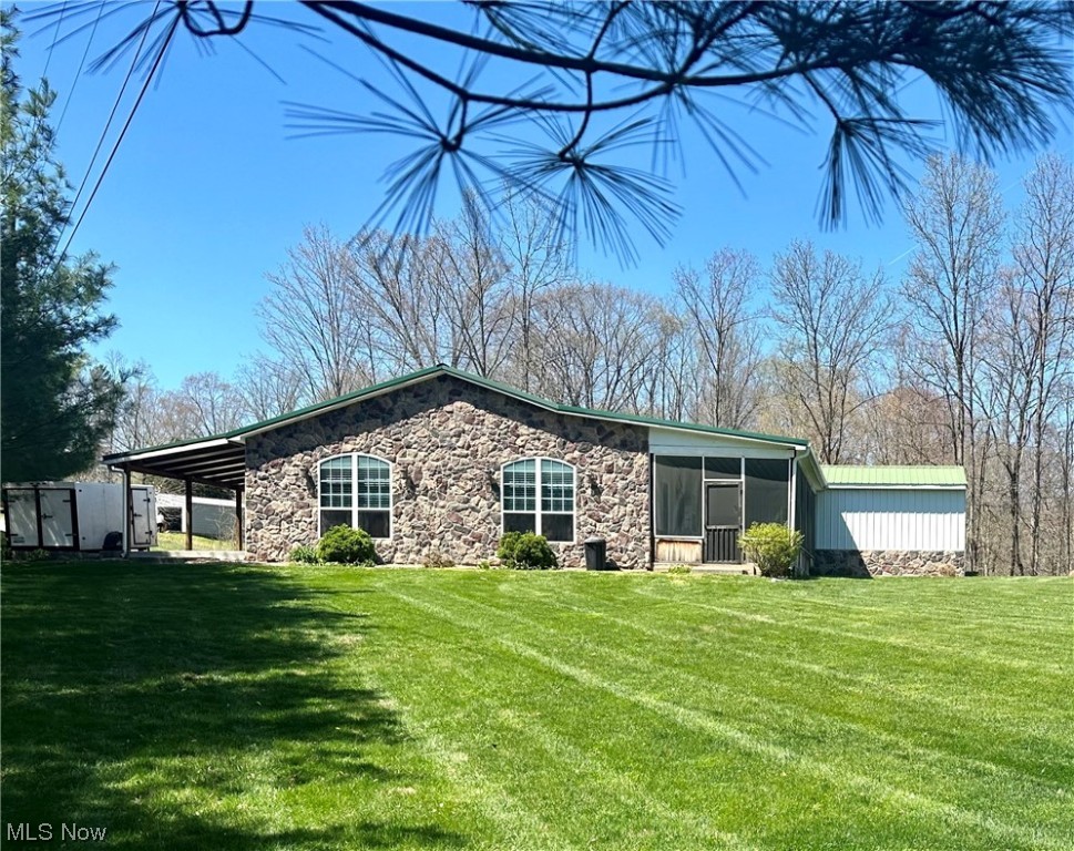 This stunning home is located right between Athens and Parkersburg, with both only a mere 20 minute drive. The country setting home is ALL 1 floor living with an open floor plan and 4 bedrooms, 2 full baths, and a recently added 2 car garage in 2019. The living room features a beautiful, stone gas fireplace to keep you cozy and warm. Kitchen has a one of a kind island made from bowling alley wood and includes all stainless steel appliances. The laundry room is cleverly concealed off the kitchen by a barn door. Spacious master bedroom with walk-in closet and full bath en-suite. The home has 2 newer heat pumps (2020), 2 new AC units (2020) and 2 tank-less water heaters (2020), 200 amp electrical service and to top that off the eat-in kitchen, living room, and master bedroom have heated concrete floors!! Sit in the recently added screen in patio (2021) and enjoy the peacefulness of your 4+ acres! There's also a 28 x 56 pole building with concrete floors and electric.