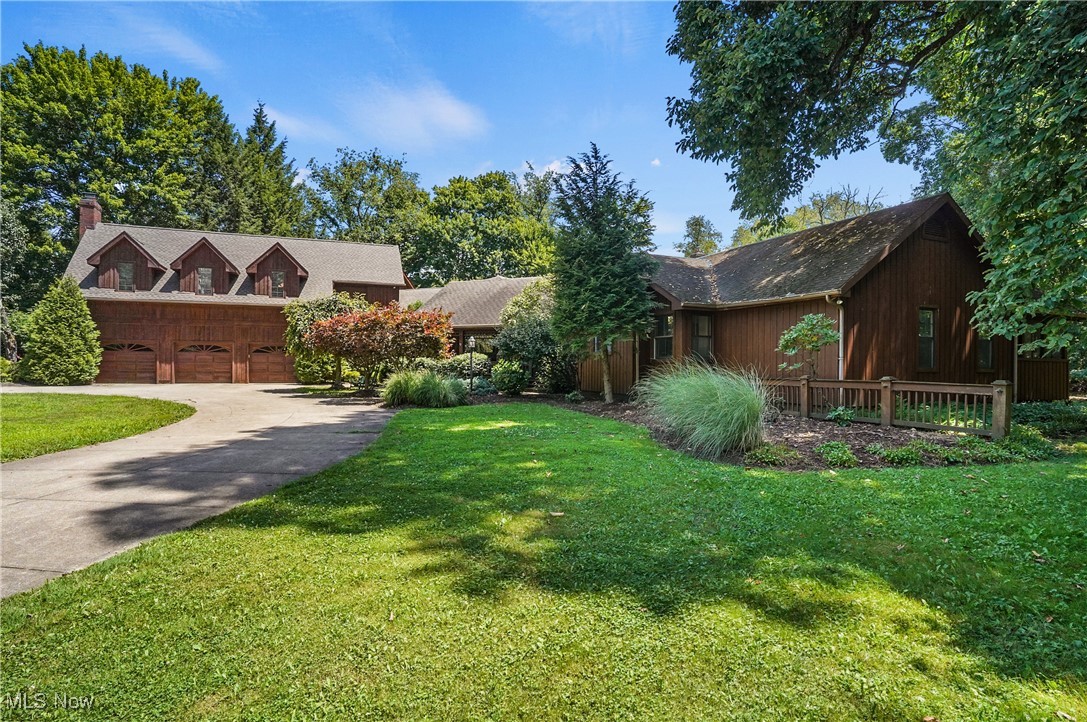 Incredible One-of-a-kind custom built beauty in a secluded oasis in Stow Schools. A drive up a long driveway brings you to your private estate with a breathtaking pond, mature trees and nature galore. Sit on your gazebo to reflect life or fish the stocked pond. The heated boat house is a perfect spot to store canoes and have fun gatherings for weekend parties. The house is a custom masterpiece with 5,045 sqft of first floor living, with architectural delights such as various vaulted wood ceilings throughout. The 1995 addition added a spectacular great room above the garage that features a stone fireplace, skylights, beamed, vaulted ceilings, pool table, built in bookcases with secret hideaways. Additionally there is a full bathroom and a room that could be a wet bar. Also in the new addition is a large bedroom/family room with a loft and built-ins, with a full locker room style bathroom. Moving into the center of the home is a beautiful dining room with glass French doors and a wall of windowed walls. The kitchen is a chefs dream with an abundance of cabinets and counter space with a center island. Step out to a sunroom with vaulted wood ceilings and a wall of windows to the back yard oasis. Step down to a sunken living room with wood vaulted ceilings, fireplace and doors to the back wraparound deck. Venture down the opposite wing where you find 3 bedrooms, one being the primary that has a door to an enclosed deck with a hot tub. Downstairs is a massive recroom with wet bar, 2 more bedrooms, another full bathroom, another laundry room, and lots of storage. The attached 3 car garage has a garden workshop with laundry hookup. An additional 3 car detached garage is a delight for the car enthusiast. This home is the perfect entertaining property, and conversely, the most peaceful retreat to escape from a stressful day.