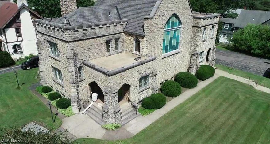 Reduced for Quick Sale! Historic Youngstown Stone Church For Sale! This Striking Building sits on 2 parcels of land and features ornate exterior and interior architecture. Former "Richard Brown United Methodist Church". 4400 SF. Church Built in 1905. Charles Owsley, Architect. Main entrance features tiled entry way into large parlor room. Front stair case leads to large room with fireplace with adjacent half bath. Large worship area seats 130+. Pews included. Back stair case leads to 2 upstairs rooms. Spacious basement has marble fireplace, large seating area, commercial kitchen with island. Commercial stove and ventilation included. 2 Public restrooms in basement. Ample parking. Short walking distance to YSU, and is situated directly across from Wick Park. (2) New High Efficiency Furnaces with Central Air For Basement and Main Floor HVAC and (3) New Heat Pumps (Heat, AC or fan) for 2nd floor HVAC Installed in late 2022., updated 200 amp electrical service, shingled roof estimated to be less than 10 years old. Flat roofs were serviced by Boak & Sons. Zoned as MU-I Mixed Use institutional. Please view virtual tour before requesting a showing. Please contact agent for more information, virtual tour and showings.