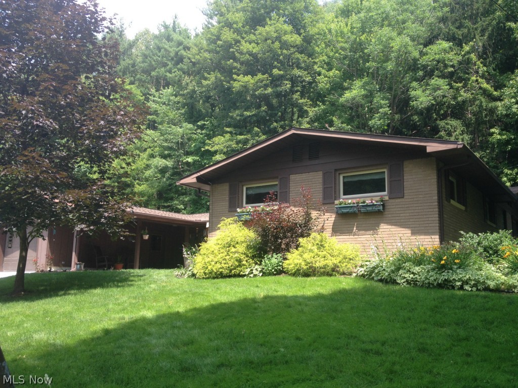 Enjoy the lake...forget the maintenance.Located in the Atwood Glens allotment that has 3 beaches for your enjoyment. Brick ranch with 3.5 bedrooms/ 1.5 baths and tons of updates. Screened back porch and concrete patio for relaxing at home when you're not on the lake. Kitchen has a wood burning fireplace, island with eating area, newer appliances, hardware and tile backsplash. First floor laundry. Kohler fixtures, solid oak doors and crown moulding all showcase the quality built into this home. 30' American Tower floating dock included. Updates in the last couple years include...radon mitigation system, roof shingles, hot water tank, drywall, paint, flooring and ceiling fans all in 2012. New windows, entry doors in 2013. Concrete drive and patio in 2014. The work is done! Buyer and seller to split the $250 MWCD transfer fee. Lease fee for 2014 is $1608.