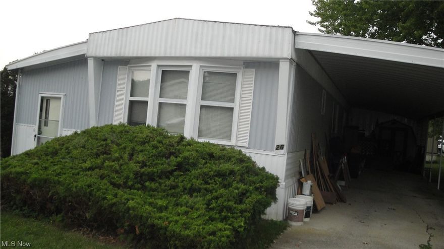 Mobile 14 x65 with huge car port & shed with elec.& nice deck. Extra room on side of mobile with storage. 2 bedroom with bath & half. 1985 Shannon.