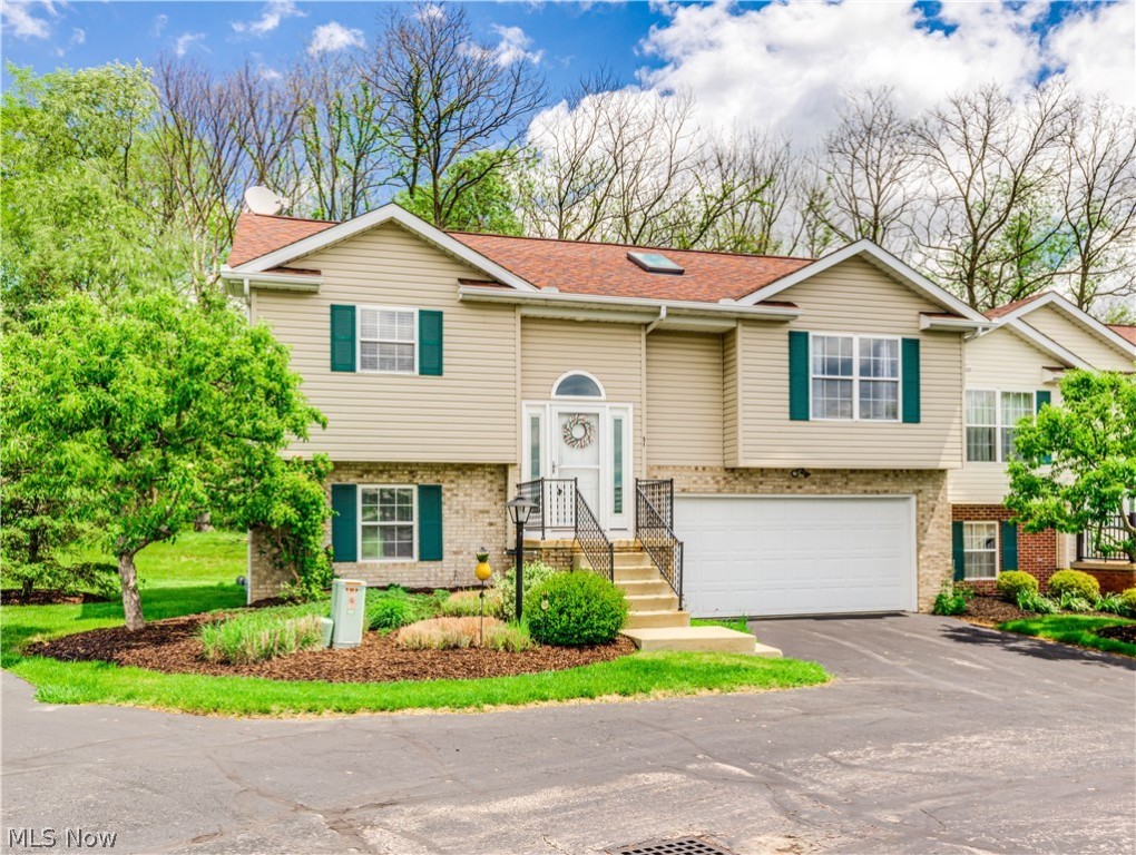 Impressive 2 or 3 bedroom condo with 2.5 bathrooms and a two car attached garage . This end unit has great curb appeal and a semi private backyard overlooking a wooded park like area from the large deck porch or from the lower level walk out patio. Step through the foyer entrance into the open and spacious Vaulted Great Room and Dining Area filled with natural light . Extensive updates throughout includes luxury vinyl floors, carpet, neutral paint and trim, light fixtures, fans, water heater,garage door and opener, appliances and more. Beautifully redone kitchen and bathrooms with quality materials and finishes throughout. The lower level is a spacious and bright family room with sliders to the patio. It has an area for a closet and could easily be converted to a third bedroom if needed. The condo sits up high enough to see beautiful sunsets and catch the fireworks on the 4th! Close to the River and hike and bike trail.