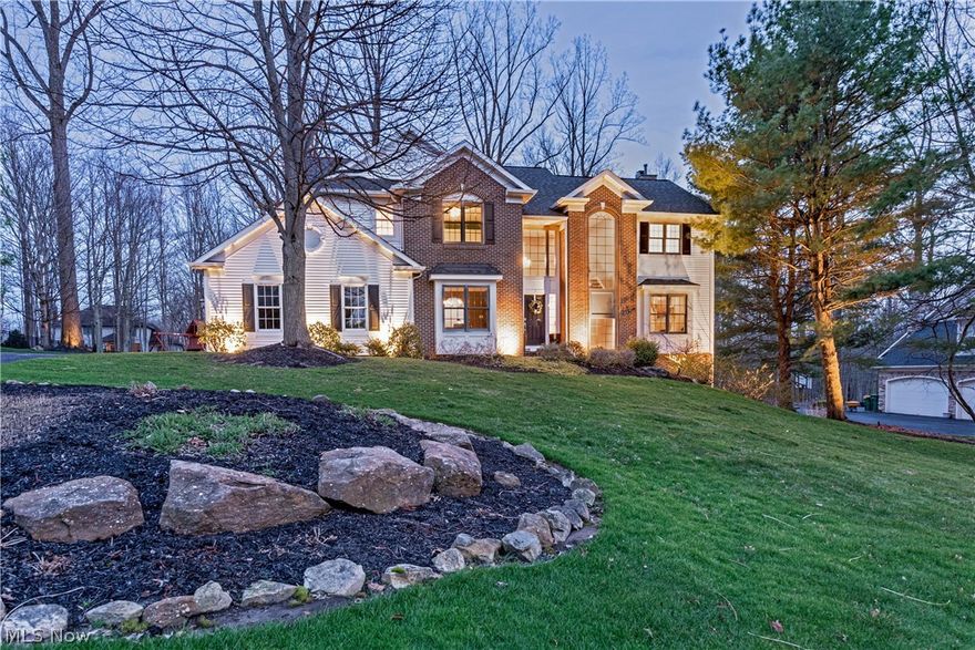 Tucked along a quiet street in the coveted Canyon Lakes community of Chagrin Falls, this spectacular colonial offers the rare combination of scale, flexibility, and style. Refined yet effortlessly livable, the home unfolds across an open floor plan designed to adapt beautifully to today’s lifestyle.
A gracious den or home office with fireplace and formal dining room create elegant gathering spaces, while the kitchen features newer stainless steel appliances, granite countertops, white cabinetry, and a breakfast area with sliding doors that open to the deck and backyard. Curved archways flow into the soaring family room with a statement fireplace and a wall of windows, filling the space with natural light. A private flex space just off the kitchen provides the perfect playroom or additional work-from-home retreat.
Upstairs, four spacious bedrooms include a serene owner’s suite with a spacious bath complete with soaking tub, tiled shower, dual vanities, and a walk-in closet. A fourth bedroom with en-suite bath offers ideal guest or teen accommodations.
The walk-out lower level expands the living space even further, newly updated with carpet and fresh décor. Here, a large recreation room, media area, fifth bedroom, and full bath create a flexible environment for guests, extended family, fitness, or additional office space, all with seamless access to the outdoors.
Significant improvements have been completed in the last two years, including new lighting, refreshed flooring, and fresh interior paint. Outside, a spacious backyard framed by mature trees offers privacy and room to play, while Canyon Lakes residents enjoy scenic walking trails, tranquil ponds, and tennis courts, all just minutes from highways, shopping, top-rated schools, and the charming shops and dining of downtown Chagrin Falls.
An exceptional property in one of the area’s most desirable neighborhoods, this opportunity won’t last long. Schedule a showing before it slips away.