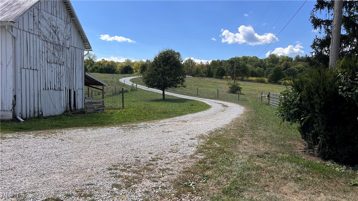 This Medina County farmstead in Wadsworth, Ohio offers a spacious residence, multiple barns, and fenced pastures with frontage on two public roads. The farmhouse includes seven bedrooms and two full bathrooms, with five bedrooms upstairs and two on the main floor, creating flexible living arrangements. The kitchen was fully renovated in 2022 with two dual-fuel commercial stoves, two dishwashers, granite countertops, and a tile backsplash. Both bathrooms were updated in 2022 with tile flooring and modern finishes. A butler’s pantry with original woodwork remains, and a practical mudroom provides a storage bench and coat hooks. Additional updates include a new roof installed in 2016 and a new well completed in 2024.
The farm features newer high tensile fencing that divides the property into several pastures, making it suitable for livestock or other agricultural use. Several frost-free hydrants are located across the property for convenient year-round water access. Outbuildings include a large barn with loft, a smaller barn, and a chicken coop, offering storage and functionality for a variety of needs. Additionally, the property also has a small creek running through the property. You do not want to miss this opportunity!