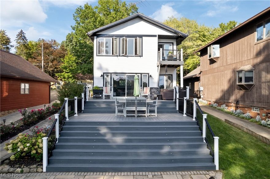 Welcome to paradise! Check out this awesome waterfront home located on the West Reservoir (main chain) close to all restaurants on the lake. Has almost 2700 sq. ft. w/5 BR, & 3 full bath. This one has had many recent upgrades, so pay attention to detail. Exterior has a newer concrete driveway w/parking for up to 8 cars w/a 2 car attached garage. As soon as you walk around back you will notice an amazing entertainment space w/breathtaking water views. Massive back trex deck w/6 person hot tub. Backyard also features custom 3 levels of new hardscape in '18 w/built in LED lighting. Down by the water has a dock, patio w/fire pit and built-in custom seating all new in '18. First floor offers a laundry room, full remodeled bath, bedroom/office, large updated eat-in kitchen & a massive living room w/amazing views. Upstairs 24x15 master bedroom is a must see w/balcony overlooking backyard, water views and a walk-in closet. Custom master bathroom new in '22 w/large tiled walk-in shower w/bench, double sinks w/granite & a huge jetted tub. Currently used as a single family, there is a second entrance to the second story & has a full second kitchen, living room, full remodeled bathroom and 2 more bedrooms. Truly unique and has separate utilities for in law suite or rent potential. Updates include, siding, flooring/lighting '18, furnace/A/C '23, flooring '22, appliances '23 and more. Too many updates to list all. This one will make a great house to call HOME, and enjoy the lake life!