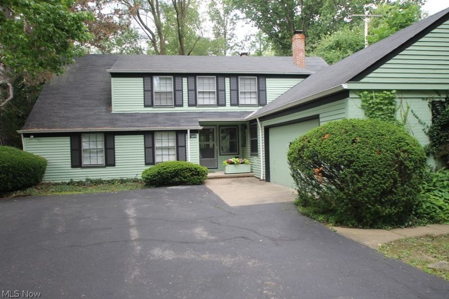 Mid-Century Modern BEAUTY!  If you love Mid-Century Modern, this home is YOURS!  Open living room/dining room with soaring ceilings, architecturally separated by brick fireplace with tile detail. Beautiful wood built-ins in dining room--buffet, storage, pass through, ETC!  Triple pocket doors make separating the living room and dining room a breeze.  Dramatic floating stairs lead to second floor, which awaits your finishing touches!  Eat in kitchen still has many of the original appliances...AND THEY WORK!  Three lovely bedrooms, 2 full baths--master suite!  One bedroom features a retro cork floor, and peg board on the walls.  Living room looks out on gorgeous landscaping complete with boulders, greenery and large open grassy area.  This one should be featured in _Dwell Magazine_.  Two car attached garage, stone's throw from book stores, boutiques, galleries, shopping.  LOVE IT!
