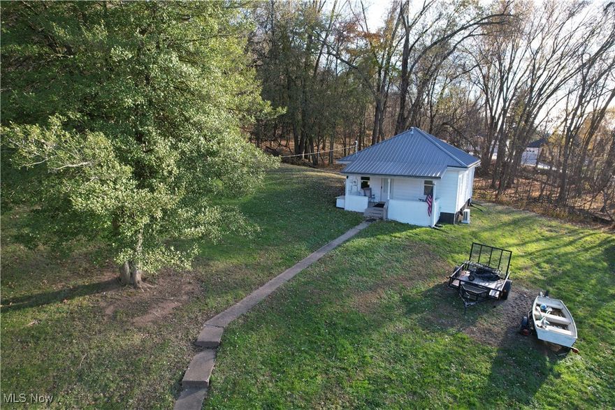 This charming 2-bedroom, 1-bath residence has been meticulously updated with modern amenities and is the perfect fit for a first-time homebuyer or anyone looking to downsize. Step inside to find new LVT flooring that flows seamlessly throughout the entire house. The updated kitchen features brand-new appliances, a stove, fridge, and microwave, making meal prep a delight. Major updates include a new roof, updated windows, and a new split HVAC system, ensuring comfort and peace of mind for years to come. The exterior boasts durable vinyl siding and a lovely covered front porch, perfect for relaxing. A separate storage building provides extra space for your belongings. This home is situated on a quiet, dead-end street, offering a serene environment and the added privacy of being the last house on the right. With all the hard work already done, this home is truly priced to sell and won't last long!