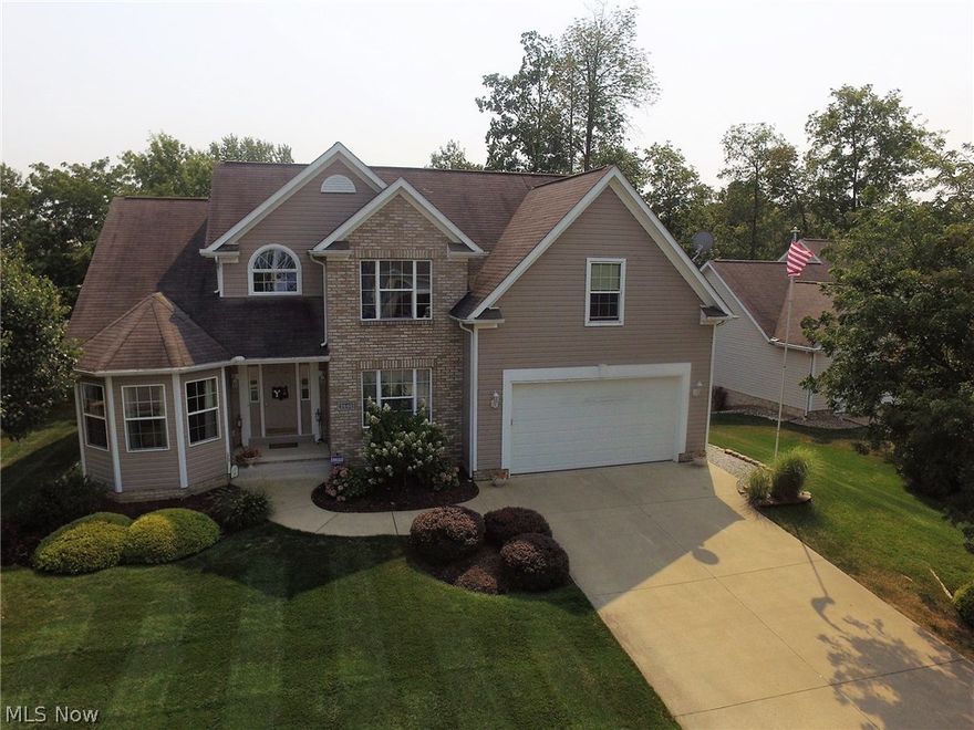 Located in the Hoover Estates Allotment, this stunning 3 bedroom, 3.5 bath Colonial has it all! Where do you start? The open floor plan with vaulted ceilings, and extra windows offering amazing natural sunlight, the hardwood floor floors and fireplace in the large, Eat-In-Kitchen? Over sized first floor master suite, with double sinks and Jacuzzi tub make this the perfect resting spot. Ceramic tile throughout the hallway, will take you into the 3 car tandem garage, first floor laundry room, and open foyer with vaulted ceiling and beautiful chandelier. The Galley style eat-in-kitchen also boasts a high ceiling, beautifully crafted oak cabinets, Corian counter tops, country style sink, and a large island to cozy up to the all stone fireplace. Featuring sliding glass doors out to your covered deck so you can enjoy those cool fall evenings, or hot summer days by the pool. The totally finished lower level features, walkout to the patio/pool area, an 11ft full bar with built-ins, seating area to watch the game, and plenty of space to grow.  THE HEATED POOL! This 15x30 above ground pool is wrapped by an all weather deck and will make great memories each summer. An additional storage/garage is located on the lower level with access from inside or out. Schedule your showing today!