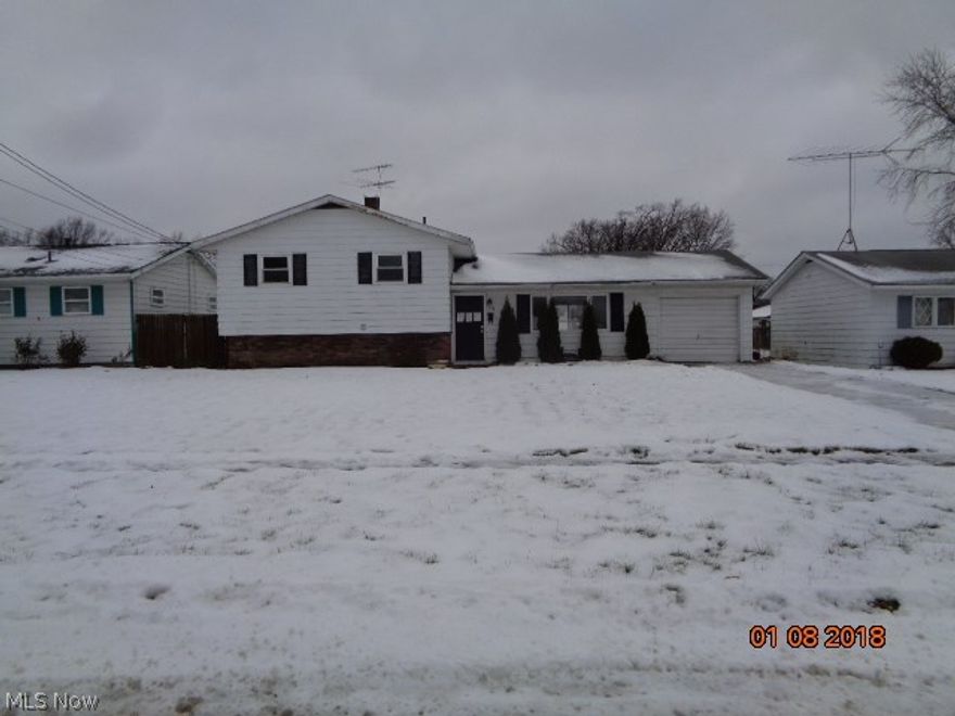Thee bedroom Split level with open kitchen dining area with sliding doors out to large backyard partially fenced! Three bedrooms up with a full bath. Lower level has a possible fourth bedroom or family room.  Separate utility area and a full bath.