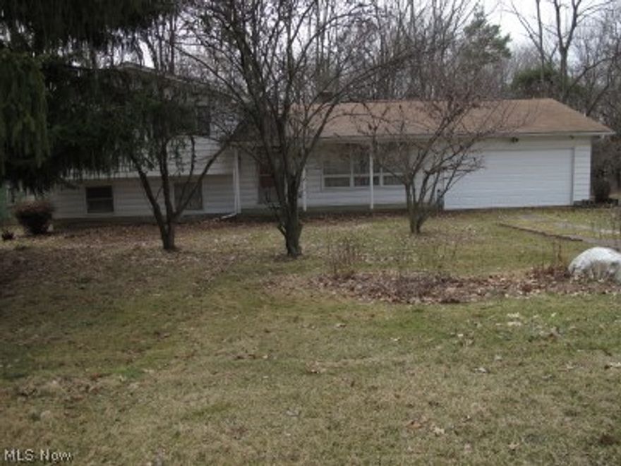 3 plus acres surround this 4 level split. Home needs updating. Convenient location but country living.