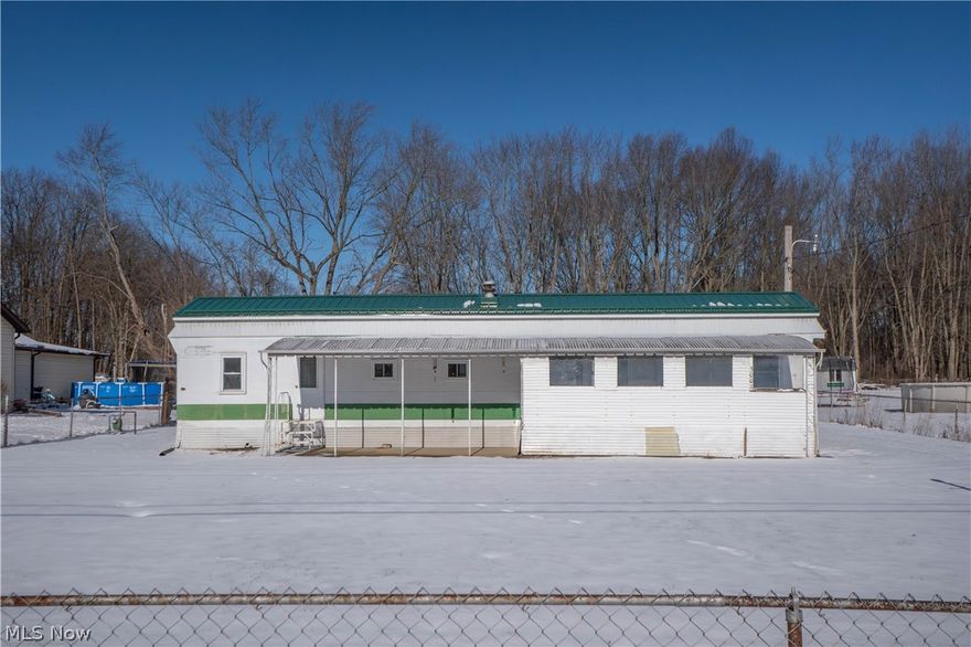 Opportunity awaits at this 2-bedroom, 1-bath home on nearly a half-acre in Akron! Nestled on a cul-de-sac street, this property features a fully fenced yard, covered front patio, partially enclosed front porch, and a detached 2-car garage. Inside, the kitchen offers LVT flooring, a breakfast bar, and opens to the living room, creating a comfortable flow for everyday living. Both bedrooms include built-in storage, and the spacious laundry/mud room adds convenience with direct access to the backyard. The home also offers well water, public sewer, updated electrical box, water softener, and plenty of outdoor space to enjoy! A great opportunity for an owner-occupant, investor, or buyer looking for value with room to make it their own.