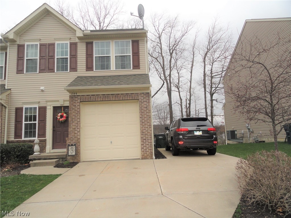 Sharp Townhome in excellent condition and desirable location convenient to shopping and access to the highway. This end unit includes an extra parking pad on the side and guest parking across the street. Plus is has a large deck porch in the back that overlooks a small wooded area to enhance outdoor privacy. Foyer entry with beautiful hard wood floors that continue into the kitchen and dining area. Appealing throughout with trendy decor. The nice open floor plan creates great space for all to enjoy. Beautiful kitchen with wood cabinets and black appliances. 1/2 bath and attached garage completes the first floor . Second floor has three bedrooms and two full baths which includes the private master suite with his and her closets and the second floor laundry. Full basement with room for storage or more living space. Home warranty included.