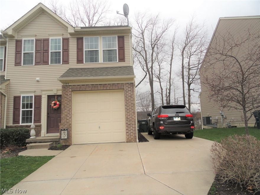 Sharp Townhome in excellent condition and desirable location convenient to shopping and access to the highway. This end unit includes an extra parking pad on the side and guest parking across the street. Plus is has a large deck porch in the back that overlooks a small wooded area to enhance outdoor privacy. Foyer entry with beautiful hard wood floors that continue into the kitchen and dining area. Appealing throughout with trendy decor. The nice open floor plan creates great space for all to enjoy. Beautiful kitchen with wood cabinets and black appliances. 1/2 bath and attached garage completes the first floor . Second floor has three bedrooms and two full baths which includes the private master suite with his and her closets and the second floor laundry. Full basement with room for storage or more living space. Home warranty included.
