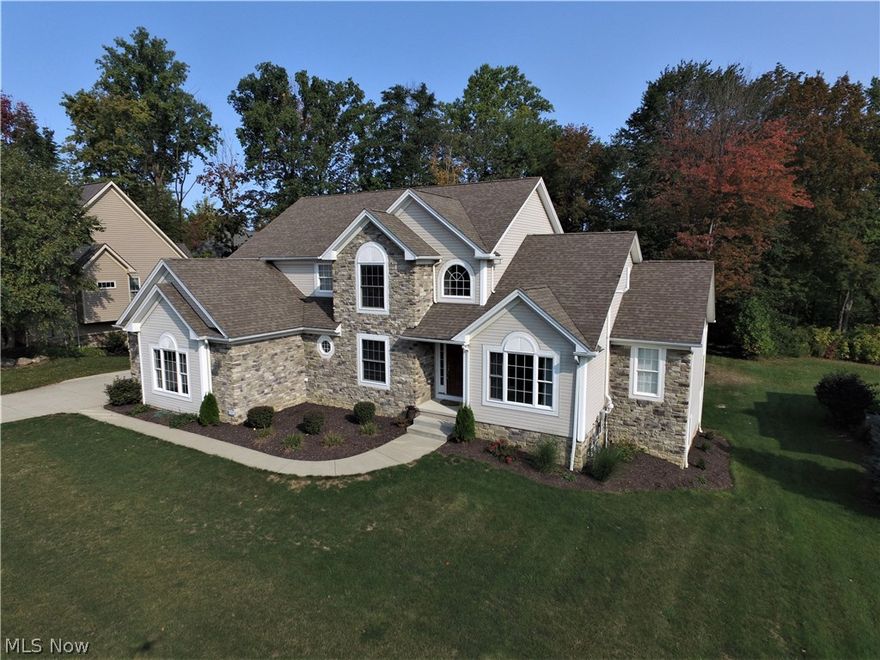 Stunning Colonial in Stonegate! This one has it all! Open floor plan features a first floor master bedroom, finished, walk-out lower level and a three car side entry garage! Huge eat-in kitchen is fully applianced, features a breakfast bar, granite counters, ceramic tile flooring and a walk in pantry! The eating area is vaulted and opens to the 12 X 20 deck. Two story great room with beautiful windows and a gas fireplace overlook the private, treed backyard! First floor Master Suite has access to the deck and boasts a large walk-in closet,  attached bath with double vanity, corner tub and split toilet/shower. Formal Dining Room, private office with french doors,  laundry room with utility tub and convenient powder room complete the first floor. Upstairs you will discover an open loft, 3 additional bedrooms (BR#2 & #3 share a jack-n-jill bath!) The finished, walk out lower level includes a open rec room, sitting area with fireplace, a huge 5th bedroom and a full bath! The basement is pl