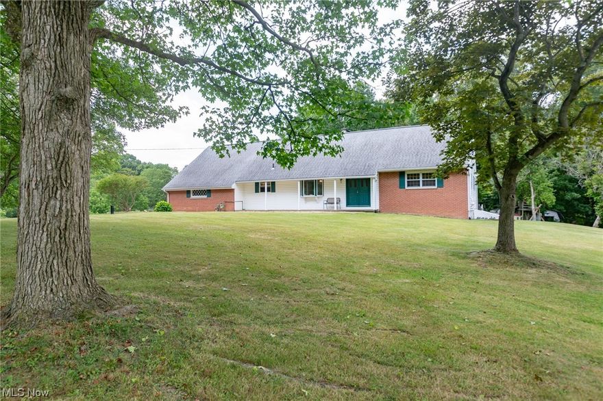 This character-filled home sits on top of 4.6 acres of scenic rolling hills surrounded by nature and is conveniently located near Rt. 8, minutes from Portage Crossing, Downtown Cuyahoga Falls, and the Cuyahoga Valley National Park. This cape cod boasts 5 bedrooms, 4 bathrooms, and more charming details than you can count. Enter through the center hall foyer, which opens into the dining and living rooms, w/ gleaming hardwood floors. In the dining room, you'll find charming details with open shelving, a bay window w/ a picturesque view, and a built-in bar cabinet. The enormous kitchen was recently updated w/ ample countertop space and storage, and a center island that overlooks the open-concept family room w/ a wood-burning fireplace. French doors open up to the heated sunroom. A remodeled half-bath and laundry room, two spacious bedrooms w/ jack and jill bath complete the first floor. Upstairs you'll find a large primary bedroom with built-in dressers, tons of closet storage down the ha