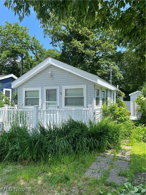 Here's your chance to own your own cabin by the lake! With public water and sewer, you could live there all year long! Cute as can be, there is an open concept that has a larger living area and a small kitchen. There is a bedroom and bath on the first level. The loft is set up as an extra bedroom but could be used for storage too! Located just outside the gate, this cabin is part of The Olive Drive Association and is being sold as the cabin only, the land is owned by the association. The residents have access to a large pavillion with kitchen and bathroom and a paved path to a private beach area. Newer windows, roof, flooring, hot water heater, and bath.
