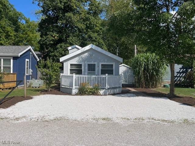 Check out the fresh new landscaping on your new summer home! Here's your chance to own your own cabin by the lake! With public water and sewer, you could live there all year long! Cute as can be, there is an open concept that has a larger living area and a small kitchen. There is a bedroom and bath on the first level. The loft is set up as an extra bedroom but could be used for storage too! Located just outside the gate, this cabin is part of The Olive Drive Association and is being sold as the cabin only, the land is owned by the association. The residents have access to a large pavillion with kitchen and bathroom and a paved path to a private beach area. Newer windows, roof, flooring, hot water heater, and bath.