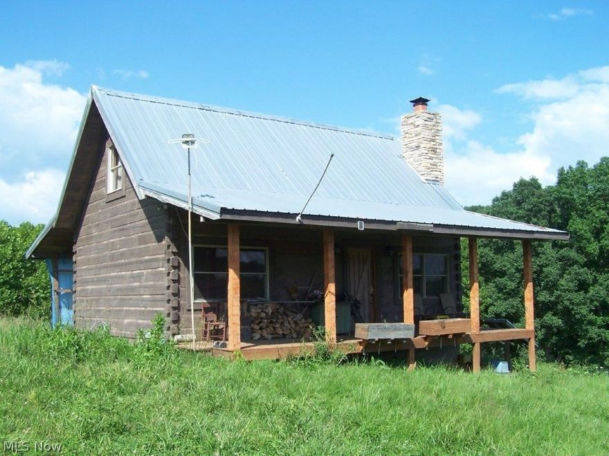 Secluded 65 acres surveyed (easy access) Beautiful Log Cabin. 2 bedrooms, 1 bath, family/media room (or extra bedroom), great-room with fireplace, kitchen, dining room, utility room, covered front & back porches. View countryside  and abundant deer, turkey, wildlife! Small creek, timber, meadows. Drilled well & septic. Solar power electric & generator. Be self sustaining! Garden area. Wonderful location. Cabin is in center of property- as private as you can get! Storage building & chicken house. Locked gate & security system.