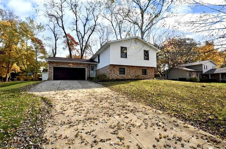Beautiful 4 potential 5 bedroom, 2 full bath home situated on a nice wooded lot in the Burroughs! This home is in North Canton School District but in Lake Township. Entering your new home into a spacious 2 story foyer.  The main level of the home includes the living room, dining room, kitchen, 3 season room, 3 bedrooms and a full bathroom.   There is a finished lower level with a family room, laundry/utility room, 4th bedroom with built ins and a potential 5th bedroom with built in bunk beds. Newly updated kitchen comes with Refrigerator, Stove, Dishwasher, Disposal and microwave and a nice pantry.  Radon Mitigation system installed in 1999.  New roof, freshly painted, new carpet, well pressure tank all done in 2020/2021.  Additional recent updates are window blinds, gas hookup for home (changed from oil heat), furnace, AC, new siding, front door and lower full bathroom.   This home is much larger than it appears from the street. There is an 14x16 outbuilding that provides additional s