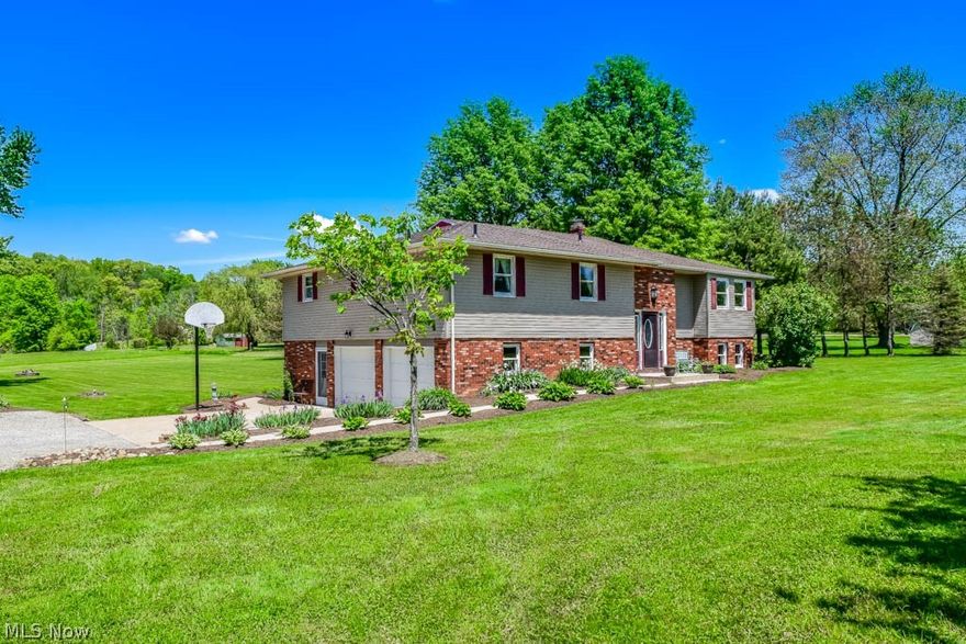 Absolutely gorgeous 4 bedroom, 3 full bath with 3,107 square feet on 5 acres! Perfect condition! Gleaming real oak hardwood floors throughout that will wow you! Plus super cozy brand new carpet in most rooms! Find your culinary inspiration in the stunning kitchen remodeled in 2013 with a center island, breakfast bar, stainless steel appliances, solid surface countertops and amazing full extension, soft close Merillat maple cabinets. Bonus walk-in pantry with extra cabinet and counter space! Host holiday meals in the formal dining room with crown molding and a beverage station. Gather in the spacious living room with French doors to the back deck overlooking your acreage! Down the hall, the master suite offers 2 closets and a private master bath updated in 2012. There are 2 additional bedrooms and a full bath. Fantastic storage with an extra deep, walk-in hall closet! Downstairs, there's a fourth bedroom with a full bath just around the corner; this is very convenient for visiting guest