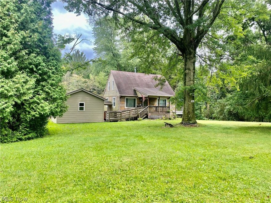 Adorable 2 Bedroom Cape Cod on close to an acre tree-lined lot in Canfield Township/Boardman Schools. Excellent location! Private, serene setting yet close to shopping, restaurants, hospital and more.  All New Windows, Gorgeous Hardwood floors, covered front porch, plenty of closet space and a full, walk-out basement are just a few of the perks of this home.  Both bedrooms have ceiling fans and nice-sized closets.  The full bath hosts a newer walk-in tub/shower combo and updated lighting. The kitchen is bright and cheery and features vinyl flooring, Ceiling fan, recessed lighting and plenty of space for all your cooking essentials. The Large Living Room and spacious Dining Room provide an abundance of room for relaxing or entertaining guests. The ramp from the driveway provides easy access to the 1 1/2 car garage and the spacious covered front porch.  Don't wait....call today to schedule a private showing.