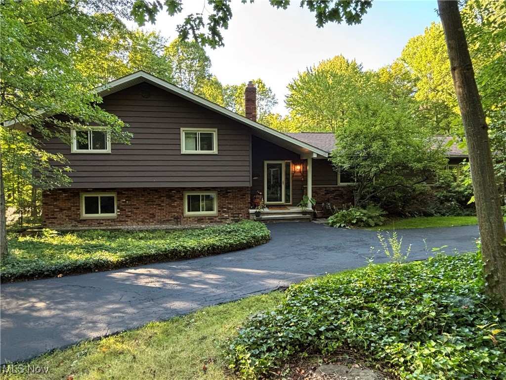 Absolutely gorgeous unique property that sits back from street and gives one the privacy they want. This home has been upgraded, remodeled and meticulously cared for by the present owners. They have thought out each remodel, proactively done upgrades and have done it with care. There is a beautiful master bedroom retreat in the rear of the home that overlooks the backyard and gives outside access to a deck. Carefully crafted built-ins for your desk area or treasures. 2 walk-in closets complete the room. The focal point of the home is the large entryway where you can enter into the sitting area, kitchen and sunroom. It's a wow!!! Imagine sitting in the morning and having the choice of a sunroom or a cozy sitting room for your coffee. The kitchen shines! Gorgeous granite, bright white cabinets and luxury vinyl plank flooring. A few steps down is the family room with fireplace with sliders out to the patio. An area adjacent to the family room is presently being used a dining area but could be a great game room, play area or desk area. A few more steps down brings you to the basement area.....large, workshop area, utilities and a full storage area under the addition. This property does not lack storage area at all!!! The extra bonus to this property is the barn. This building could hold 2 cars, has an upstairs workshop and again tons of storage! The long driveway has 2 parking pads for visitors. You have to see this house to appreciate all the things Mr. and Mrs. Proud Homeowner have done to call it theirs. Fenced backyard, brand new HWT, newly sealed driveway and clean as a whistle. Schedule an appointment today!