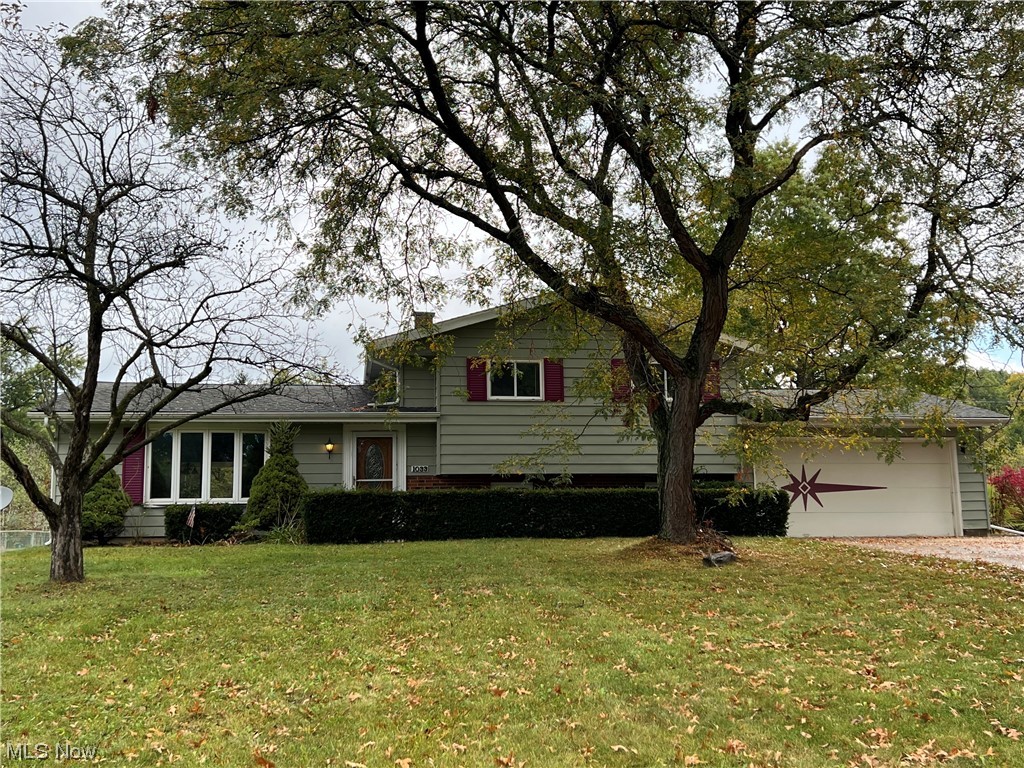 Welcome Home! This split-level house welcomes new owners with an open floor plan that is emphasized by vaulted ceilings and accented by the decorative beams above. This house provides the perfect opportunity to add one's own touch and style! The open-concept family room, dining room, and kitchen on the first floor allows for several possibilities should one want to enlarge or update the kitchen, use the space for a larger living area or dining area, or keep things just as they are. The front bay window and the back sliding glass doors allow for abundant natural lighting throughout the first floor area. Upstairs, one will find three bedrooms and a bathroom, while on the lower level a living room, an additional bathroom, and a bonus room can be found. New owners can leave this lower area as it is or spruce it up a bit if they choose and enjoy the added bonus room as an office, craft room, or possibly even additional storage. The spacious backyard is overlooked by a covered patio just per