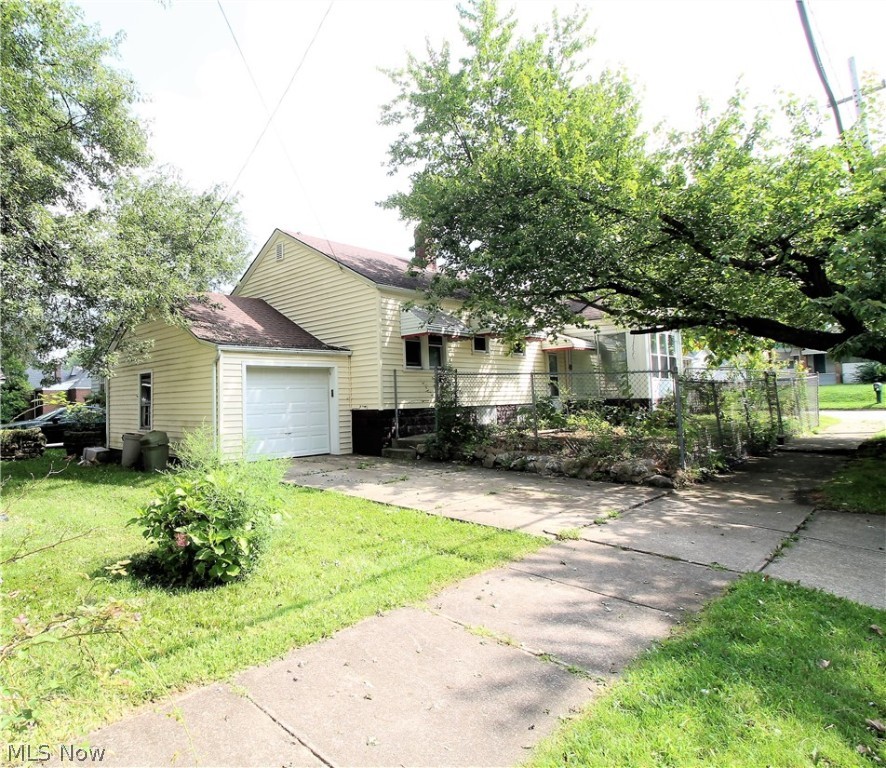 Welcome to this charming updated two bedroom, one full bath spacious ranch home. This fabulous home offers a newer roof, windows and siding. Come on into this freshly painted, new carpet (2021) through out home to the living room which has large windows to let the natural light shine through and is open to the large dining room which has a built in cabinet and leads to the bright kitchen with plenty of cabinets, new vinyl flooring, refrigerator and stove. The full bright bathroom has new vinyl flooring. There are two large bedrooms that have ceilings fans. Lower level offers plenty of space for entertaining, work out area, etc. You will find an enclosed patio area for you to sit out and enjoy. There is an attached one car garage. Fenced in area. Beautiful backyard to sit out and enjoy or entertain. New Hot water tank. Precious memories begin right here!