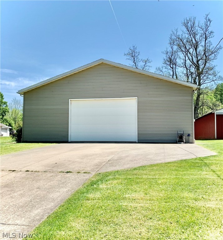 Are you looking for a building to start your business, or need additional storage space for your vehicles, boats and 4-wheelers? This 40 X 80 garage of pole barn construction has just what you need. Built in 2007, it offers a concrete floor, 200 amp electric service, public water, garage overhead door (10 foot high by 16 foot wide opening), a second, smaller garage door in the rear with openers, man door, and a nice concrete driveway which could accommodate approximately 6 vehicles. Located on a level lot in the village of Lore City with easy access in and out. Includes a Dannmar car lift, and the riding mower and Honda ATV are negotiable. There are so many features of this building it will be ideal for your commercial or personal use.