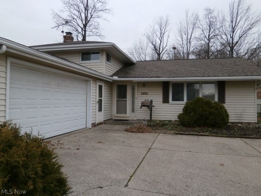 Offers the extra room you've always needed! L-shaped living room, dining room, kitchen with oak cabinets, lower level family room with fireplace, separate laundry area. Three bedrooms up and a full bathroom. Rear fenced in yard with patio area. Convenient two car garage. Live more cheaply in your own home! Seller will not make any repairs.