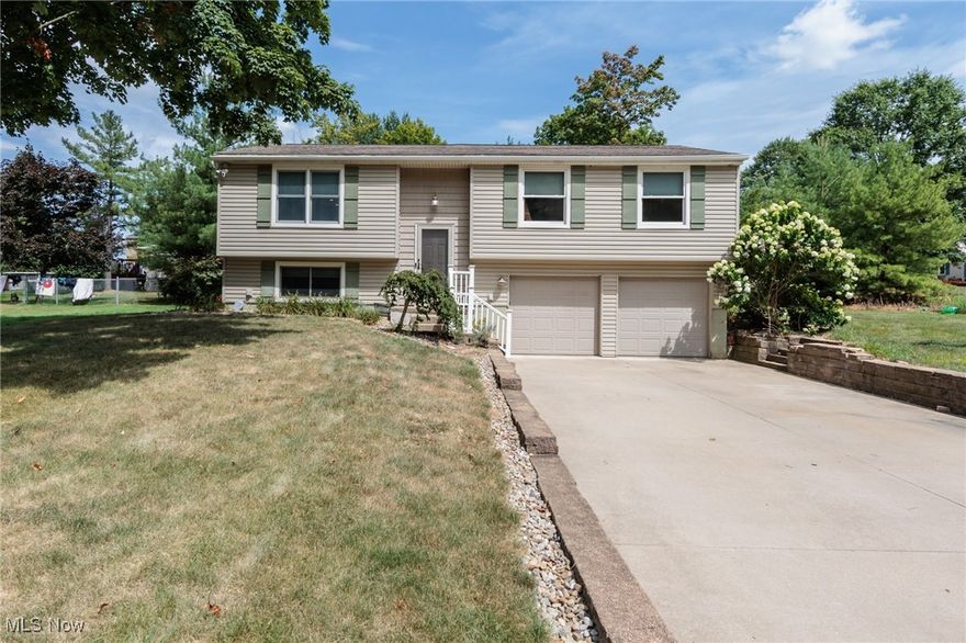 A spectacular Green bi-level with 3, possibly 4, bedrooms and 2 full baths.  This updated home features newer LVT flooring throughout the main level.  A large and open living room has an electric fireplace.  The 15x12 Master Suite has an updated bathroom.  A large kitchen has been updated, and will include all of the appliances.  The lower level is either a large family room, or could be used as a 4th bedroom with huge walk in closet.  A good sized back yard is private, and features a wonderful fish pond, brick patio, and brand new multi tier deck.  There is an attached 2 car garage that is heated, tankless hot water, new doors throughout, and so much more.