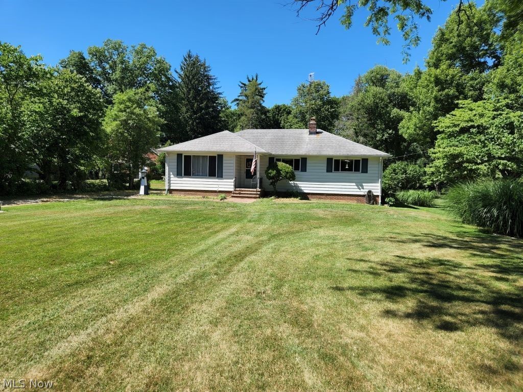Don't miss this rare opportunity to own an affordable ranch home in Brecksville on almost an acre located in prime location across from the Brecksvlle Reservation. This family built and owned home offers many nice quality features. As you enter the home thru the separate foyer with newer laminate floor and built-ins the huge great room with hardwood floors welcomes you. From there you proceed down the hall to find an updated half bath, four generous sized bedrooms and a full bath with tile floor and walls. The enormous eat-in kitchen with newer laminate flooring and refrigerator awaits you in the back of the house and comes fully applianced. A wonderful enclosed porch with vaulted ceiling, composite flooring, and three walls of windows is the perfect place to relax and overlooks the private tree filled and lined yard. In the lower level is a partially finished rec room perfect for entertaining or as another living space. On the other side is tons of stoarage and a shower with sink. A 3