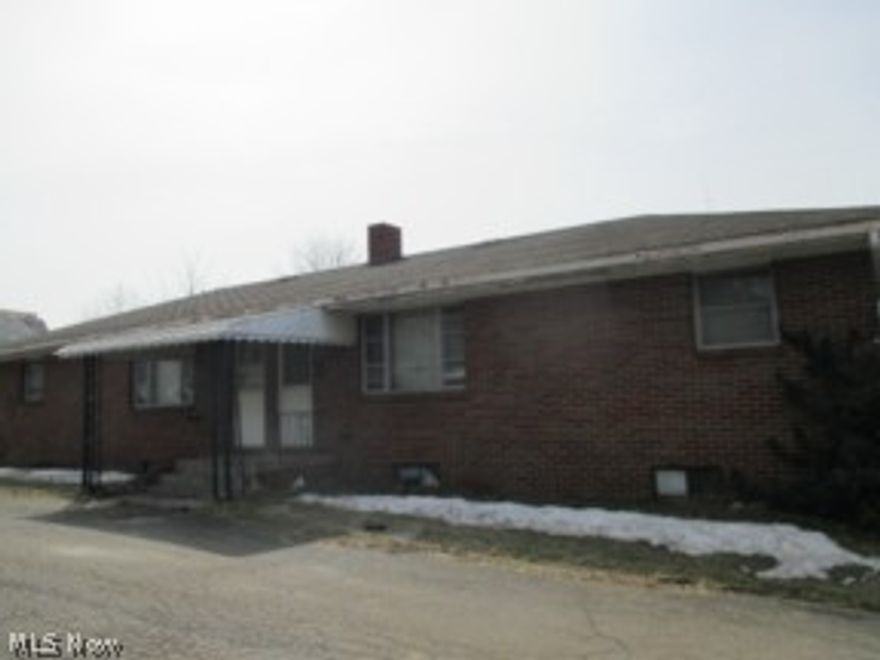 Brick, 2 unit building with 2 bedrooms/1 bath per side, separate full basements and 3 car garage...property sold as is