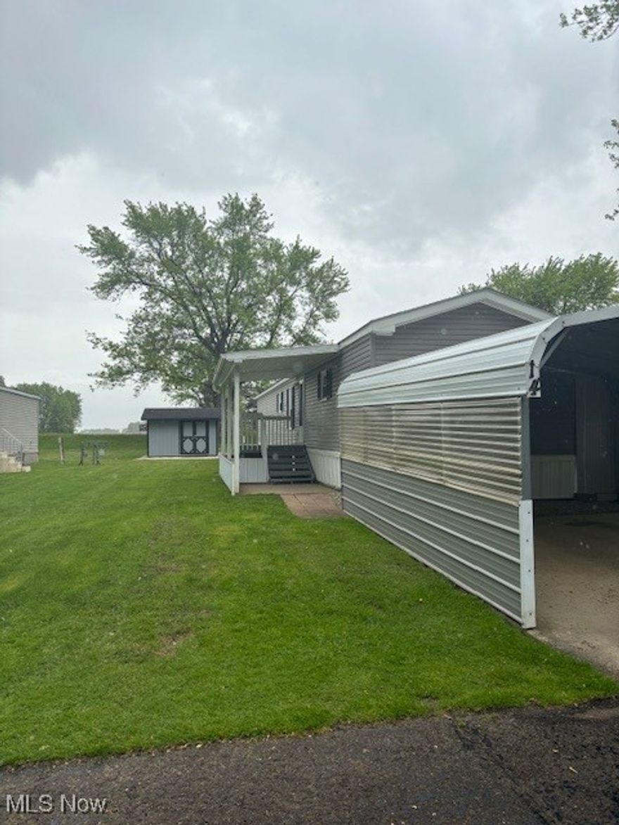 Come see this extremely well maintained mobile home in a country setting.  This home has 3 bedrooms, 2 full baths of which one has a walk-in shower.  This mobile home is 14x70 and has two entrances.  Both covered porches on the front and the back built on in 2024.  The Carport is 20’x18’ and has a new shed 12’x10’.  There are newer doors 2020, New AC 2024, and new windows 2024.  The furnace is gas, HWT electric. There is a fully stocked fishing pond in the back of the lot for park residents to enjoy! Come check out this home and call with any questions!