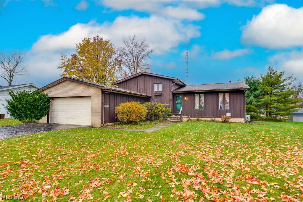 Just listed this cozy split-level on a dead end street in Alliance! This home has so much character! Just waiting on someone to do some cosmetic finishing touches to transform it into the perfect home. Walking in the front door, you'll find the large living room with plenty of natural light, the dining area and kitchen. The kitchen features lots of cabinet space, dishwasher, range, fridge and microwave for the new owners. On the second level you'll find the master bedroom with good closet space and 2 other bedrooms. The first full bath is extra large and features a double vanity with shower and tub combo. Heading to the lower level you'll find the large den with a wood stove to cuddle up to! Also in the lower level is a bar area, perfect for entertaining and a full bathroom with standing shower. The bar area leads out to the 2 car attached garage. The basement offers lots of storage shelves as well as a washer and dryer. Outside features a nice sized yard, a storage shed and a sun porch! Don't miss out on making this lovely split-level your home sweet home!