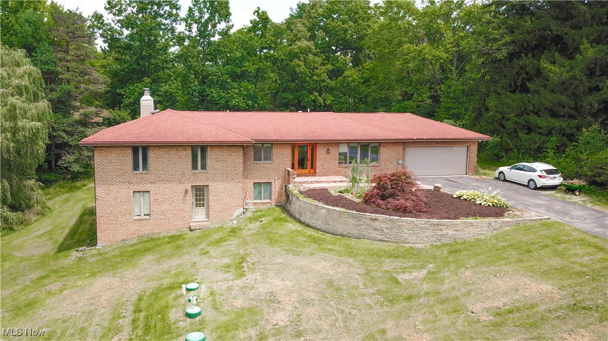 Welcome to this beautifully maintained 4-bedroom, 3-bathroom brick ranch, perfectly situated on two parcels totaling 1.61 serene acres. This home offers the best of both worlds, peaceful country living with the convenience of nearby shopping and national parks just minutes away. Step inside to discover a thoughtfully designed main level featuring a spacious living area with a fireplace, first-floor laundry, and generously sized bedrooms. The bright and airy walk-out basement is fully finished and boasts its own private entrance, complete with a second kitchen, bedroom, bathroom, and large living space with another fireplace, perfect for extended family, guests, or potential rental income. Large windows throughout the basement bring in beautiful natural light, creating a warm and inviting atmosphere. Enjoy outdoor entertaining with two expansive decks, ideal for hosting gatherings or simply relaxing and enjoying the view. A professionally constructed retaining wall (2022) adds structure and charm to the landscaped front yard. Additional updates include a new septic system (2021), brand new furnace and A/C (2025), and a home warranty included for extra peace of mind. Don't miss your chance to own this versatile and move-in-ready home in a great location. Schedule your private showing today!