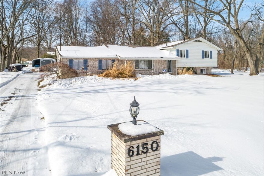 Amazing and serene location in Manchester LSD! Welcome to 6150 Terrace Hills Dr. a sprawling 4 level split level with over 2000 sq ft, 4 beds, 2 full baths, situated on .60 of an acre loaded with tons of recent updates. Located at the end of a tranquil & quiet cul-de-sac surrounded by mature trees on a large flat lot, you will love how off the grid the location is, yet still close to Portage Lakes State Park boat ramps & hiking trails, schools, shopping, & local restaurants. You will love the natural light, vaulted ceilings & oversized NEW windows & carpet as soon as you walk in! 3 bedrooms upstairs w/ spacious closet space, new carpet & remodeled bath w/ luxury plank. Downstairs find a cozy wood burning fireplace, 4th bedroom, 2nd full bath, walk-out basement to covered patio w/ gas hook-up for grill and huge side patio with concrete table & chairs. Lower level with wet bar, new carpet & plenty of utility room storage. *NEW* Updates- NEW custom windows w/ lifetime guarantee, carpet th