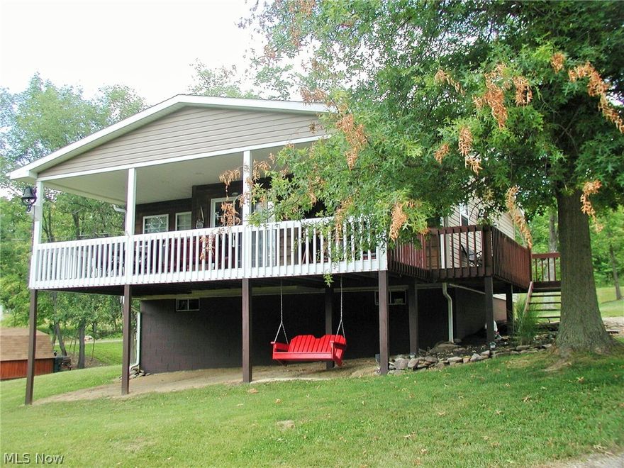 Easy living-easy style in this get-away or full time bungalow at Leesville Lake. Open floor concept with living room that is highlighted by cherry flooring with wood strips. Eat-in kitchen with eating bar plus sliding glass doors that lead you out onto the spacious wrap deck. Lower level walk-out could be easily finished to your liking. Spic and span 2 car detached garage has room for a workshop. All of this rests on over 1/2 acre. Close to lake and Petersburg Marina. What a beautiful setting and perfect location.