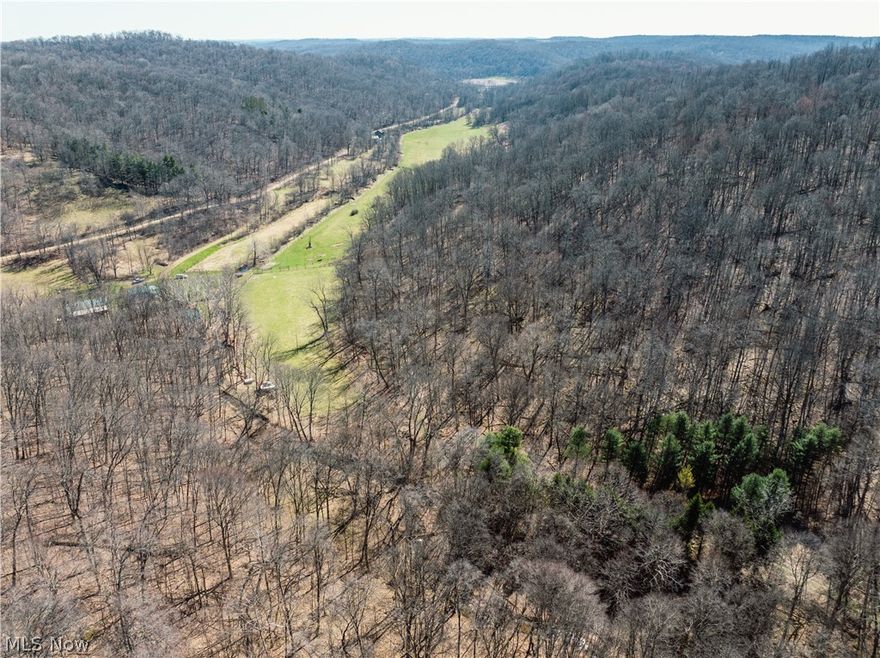 Live Auction 5/02/2026 10:00 AM - Combination Parcels 1-8 188 acres with over 4300' of road frontage -This exceptional 188-acre offering of Holmes County land presents a rare to the market opportunity to own real estate in the well-known Stillwell area. Located just seconds from a paved road, the land features an older ranch home, a 35' x 56' pole building, private septic, and a spring-fed water supply. The setting of the home offers peace and quiet, privacy, and ample land for gardening or animals. For the hunters, this property is situated in one of the county’s most sought-after hunting areas. Stillwell is well known for its hunting, and this property is no exception. Lots of deer trails, rubs, and scrapes, and each parcel is accessed from the east, providing favorable prevailing wind access and multiple ideal locations for food plots. A well-established trail system runs throughout the property, providing easy access. There is a nice ridgetop that spans most of the property, while the remainder of the land has a nice roll to it with a strong running creek, tons of road frontage, fenced pasture areas and ample building sites throughout. Most of the harvestable timber has already been marked and sold; these trees will be removed following the sale and are not included in the transfer. This selective harvest is expected to enhance the wildlife habitat and improve access with additional trails, bedding/cover, and browse. Whether you’re searching for a peaceful building site, prime hunting land, pasture ground, or just an investment, this property offers endless potential.