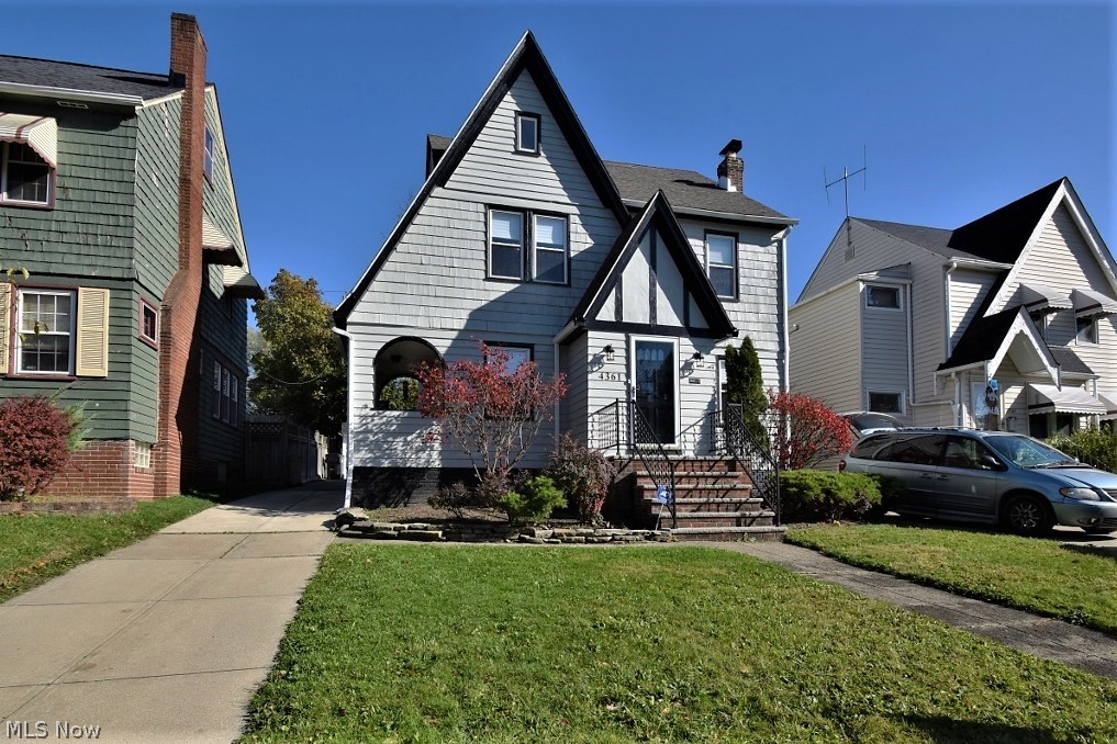 This magnificent 1931 Tudor Colonial in Old Brooklyn truly packs a punch! Freshly painted exterior! Hardwood throughout; a spectacular wooden banister, gorgeous built-ins, and details harken back to yesteryear. VERY Cleveland! Spacious and high ceilings give it a grand vibe. There is an oversized kitchen, with large French-door fridge, plenty of room for a chef to get to work! The elegant grand dining room is waiting; the ceilings all have lovely detailing as well. The long large front room has a stunning fireplace that mixes brick and carved wood for a unique look. The entranceway offers a closet plus extra room for more, a hook and bench setup perhaps? From the first floor head outside to the keyhole covered side porch, which is a favorite detail of this home to be sure. Upstairs offers 3 large bedrooms, plus a lovely sun room that would be an excellent office or study. Also on the second floor is the big bathroom. Heading up to the third floor you'll discover an extremely large bedr