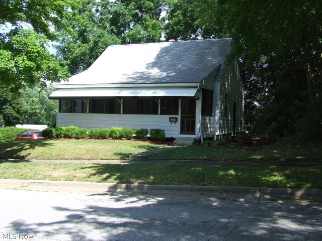 Stop and see this cape cod style home that is much bigger than it appears. Sitting on a double lot, this home has a nice sized, flat back yard and mature trees. Inside this immaculate home you will find a neutral living room, kitchen, and extra large first floor family room. Two bedrooms with original oak hardwood floors and a full bath complete the main living area. Upstairs is a large dormer style bedroom, big enough to share. The partially finished walk-out basement has a large finished rec room with built-ins, a laundry room with a bonus shower, and a workshop area with access to the attached one car garage. Updates include windows and electric in this well maintained home. Home warranty included.