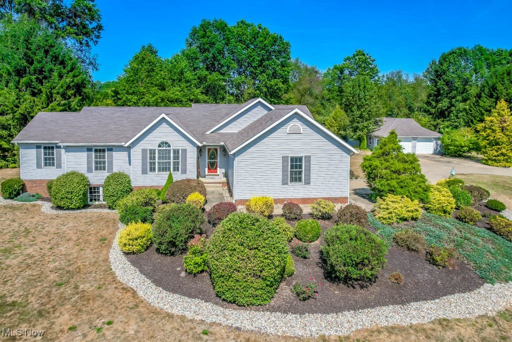 Prepare to fall in love with this peaceful custom built ranch escape on over 3 acres in Lake Township with garage space for six cars! The setting feels like your own getaway, with a pond, mature trees, and wide open space. Thoughtfully designed and well maintained, this home offers over 3000 square feet of single floor living plus a lower level rec room for even more room to spread out. Just off the foyer, a home office with French doors, a Palladian window, and crown molding is ideal for working from home. The vaulted living room is bright and airy with a gas fireplace as the centerpiece. The eat-in kitchen features newer stainless steel appliances, a tile backsplash, ceramic tile flooring, under-cabinet lighting, and plenty of custom cabinet storage, while French doors open to the sunroom, a perfect spot for morning coffee.
The primary suite serves as a true sanctuary with a jetted tub, double vanity, step-in shower, and deck access with a hot tub that’s negotiable with the sale. Two more bedrooms, including one with a walk-in closet, share the main full bath, and a guest bath doubles as the main level laundry. The lower level is a great gathering spot, complete with a rec room and another full bath with a shower.
Unwind outdoors on the deck or paver patio and enjoy the peaceful surroundings. With both an attached two car and detached four car garage, there’s plenty of room for parking, storage, or workshop space. Zoned agricultural, this property could be the perfect spot for a hobby farm, all while being just minutes from shopping and restaurants.
Schedule your showing today and see for yourself why this is the perfect place to call home!