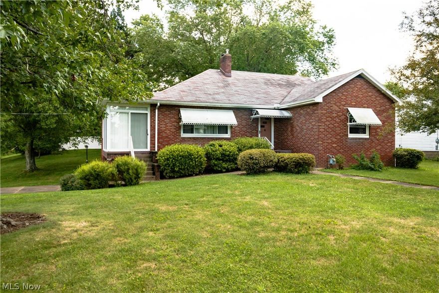 Very nice all brick 4 bedroom home with over 2,400 sq. ft. of living space sitting on a corner lot in Waynesburg. The main level features a bright kitchen with plenty of cabinet and counter top space, a large formal dining room with hardwood floors, a huge living room with built in bookshelves and hardwood floors, a relaxing 3 seasons sun room overlooking the park, 3 ample sized bedrooms all with hardwood flooring and a full bathroom. Upstairs is a large bedroom with walk in closet, a 1/2 bathroom, hardwood flooring and plenty of attic storage. The walk out lower level has a big finished rec room with gas logs fireplace, a carpeted bonus room that could be an office or workout room and an unfinished side with laundry area, another 1/2 bathroom and more storage. Other features include an attached 2 car (tandem) heated garage with opener and plenty of room for storage, a cement driveway, updated vinyl replacement windows, loads of closet space, updated electric service panel, nice corner