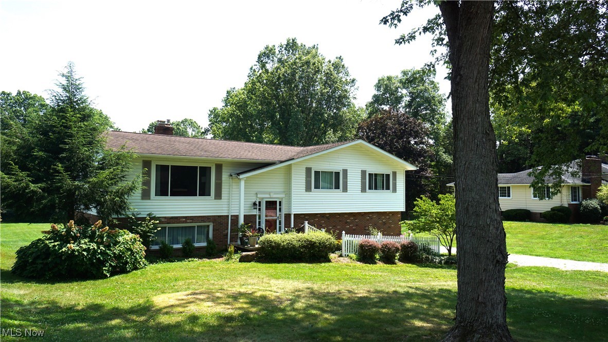 Looking for more than 1 acre in Tallmadge? Look no further! This beautifully landscaped 4 bedroom/2 ½ Bath Bi-Level is set on 1.44 wooded acres in a peaceful neighborhood in Northeast Tallmadge. The renewed front porch offers a nice place to relax and enjoy the evening sunset. Upon entering the home, the split landing leads you up to the main living area or down to a nicely finished lower level. A spacious Living Room welcomes you to the home. Beautiful hardwood flooring winds throughout the adjoining spaces including the fully equipped kitchen with closet style pantry and Dining area while the numerous windows provide considerable natural light. Down the hall, 4 nicely sized and recently carpeted bedrooms create the sleeping quarters. A galley style bathroom with over-sized vanity, tile backsplash and shower/tub combo serve the 4 bedrooms while a guest bath conveniently located just off the kitchen rounds out the Main Level. At the foot of the stairs in the Lower Level a generous Family Room with rustic stone fireplace, barn beam mantle and gas starter provide an inviting place to gather. Additionally, the original garage has been converted into an enormous Recreation Room providing a flexible 3rd living space to use as you please. A substantial utility room houses the laundry, built-in storage, and is enhanced by a magnificent glass block window adding tons of light. A second full bath is nicely decorated with a ceramic tile floor, walk-in shower stall and extended vanity. An attached 2-car garage provides access through the utility room. Outback, a sprawling yard is highlighted by a picturesque flagstone patio perfect for sitting and sipping your morning coffee while watching the butterflies and hummingbirds or enjoy a crisp fall night gathered around the firepit. Recent Updates: Rec Room Heater – ’23, Main Level Carpet – ’19, Gutters – ’17, Windows, Siding, and Front Porch – ’16, A/C – ’12, Roof – ’03. Contact your favorite Realtor to schedule a showing today!