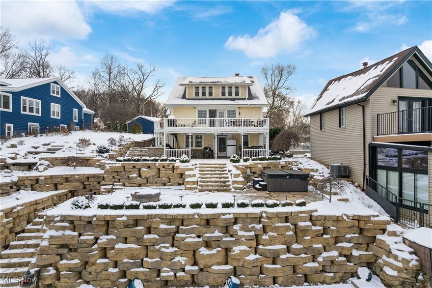 An entertainer's DREAM! Nestled on the shores of East Reservoir on the main chain of Portage Lakes sits this majestic 3 level home with 95 ft of lake frontage with views of the iconic Portage Lakes clock tower.  A mix of old charm with built-ins and stained glass coupled with modern updates; truly a one of a kind treasure. 2 car garage plus parking for 8 cars! 5 bedrooms (with additional flex room that could be used as a 6th bedroom in lower level), 4 full baths, 3 full kitchens; including a top level in-law or junior suite. Walkout lower level features a kitchen for entertaining guests lakeside, 6th bedroom, full bath, and large recreation room with dining area and heated floors. Main level features living room with views of the lake and French doors to the deck, 2 full baths, 2 bedrooms, updated kitchen with granite countertops, plus Master bedroom suite with multiple closets and updated master bath and tiled shower. The seller has made extensive updates - including a massive landscaping update with waterfall, exterior lighting, 2 new docks and lift. Recognized on the cover of a publication of the Ohio Landscape Association magazine, the exterior lakeside stonework lined with perennial flower beds features gorgeous multi-level entertaining spaces with firepit, hot tub, covered gazebo, and outdoor grill. Additional updates include a new roof, updated main level kitchen with beautiful granite counters and backsplash, and basement. Turn up the charm, fire up your pontoon, call your friends, and stay awhile. Make this one yours and start living your dream on the beautiful Portage Lakes!