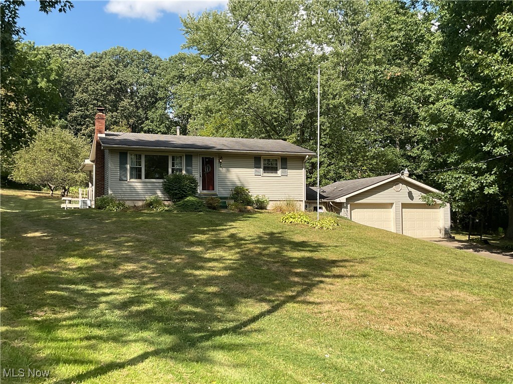 Fine 3 Bedroom, vinyl sided home situated on a 1+ acre park like setting located in Perry Twp & Perry Schools near Lohr Elementary School. Features carpeted living room w/ barn siding, eat-in kitchen w/ wood cabinets, range, refrigerator & dishwasher which leads to a 2-tier deck & backyard for those relaxing evenings. A Master bedroom & 2nd bedroom, ceramic tile bath w/ tub & shower all located on the first floor. Full walk-out lower level family room w/ gas fireplace & built-in bookshelves, 3rd bedroom, laundry room, Rheem forced air furnace w/central air, electric water heater, shower & water softener. The breezeway leads to 2 car attached garage, plus additional 1 ½ car garage / workshop. This home has vinyl replacement windows, was built in 1959 and the taxes only $1,249.33 per half year. Home sells at Absolute Auction!! Look this one over and buy at your price!!